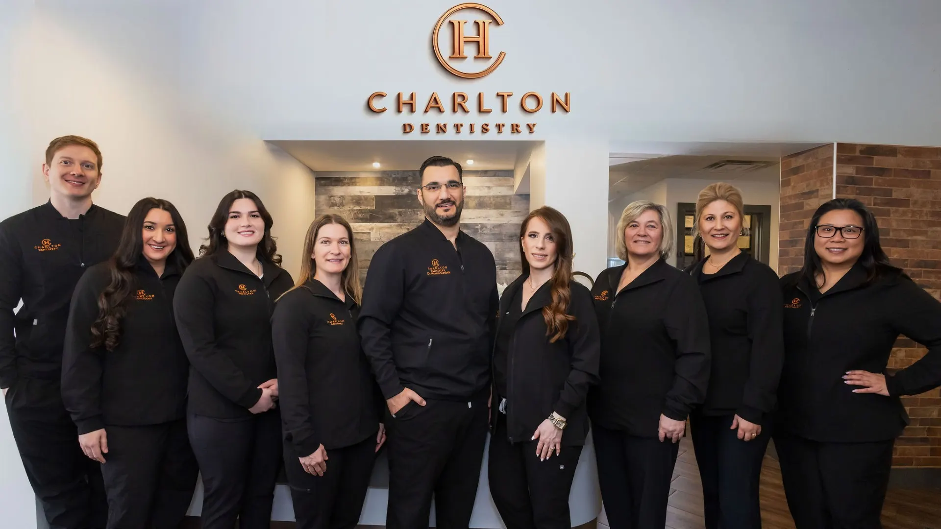 The Charlton Dentistry team gathered under the clinic logo