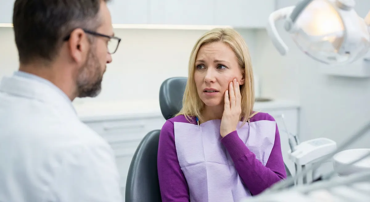 Emergency dentist Hamilton performing urgent triage and pain assessment on a patient experiencing acute tooth pain at Charlton Dentistry.