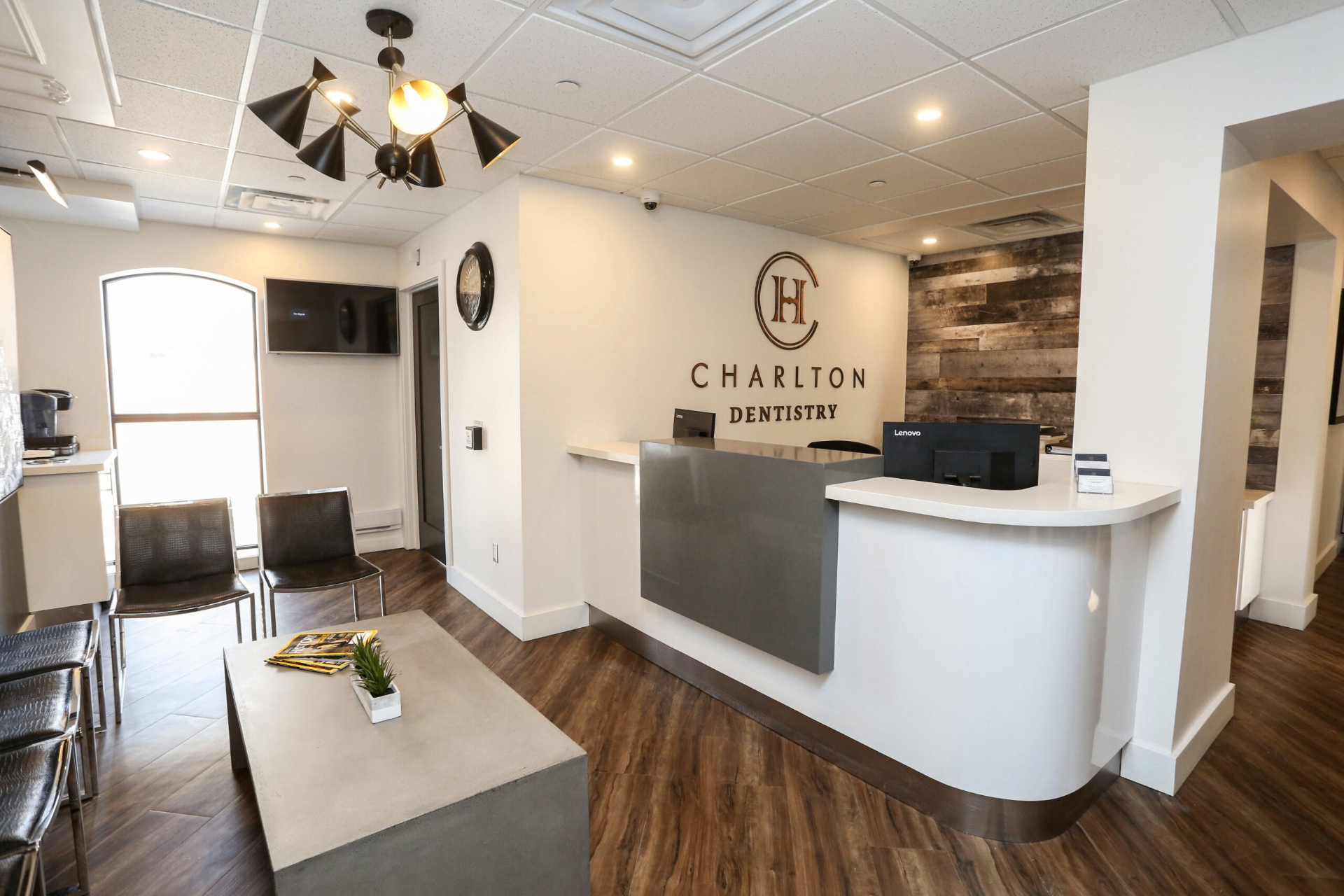 Dental checkup Hamilton, welcoming reception area at Charlton Dentistry in Downtown Hamilton with the branded signage behind the front desk.