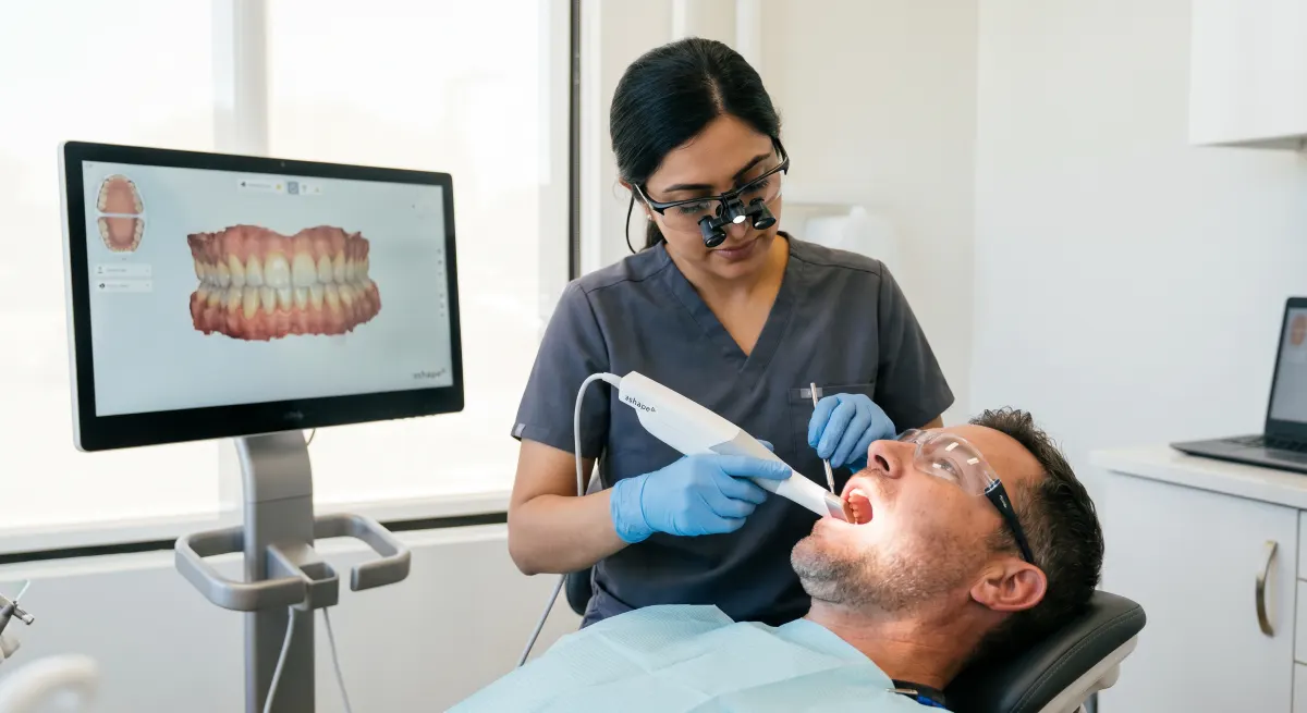 Same-day crowns Hamilton, dentist using a CAD/CAM intraoral scanner to capture a digital impression for a same-visit ceramic crown at Charlton Dentistry.